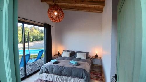 a bedroom with a bed and a view of a pool at Grado8punto8 Glamping Valle de Los Artistas in Lolol