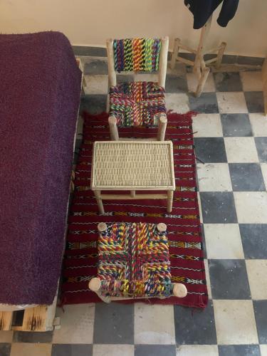 two chairs sitting on a rug next to a couch at Dar MIMA in Rabat
