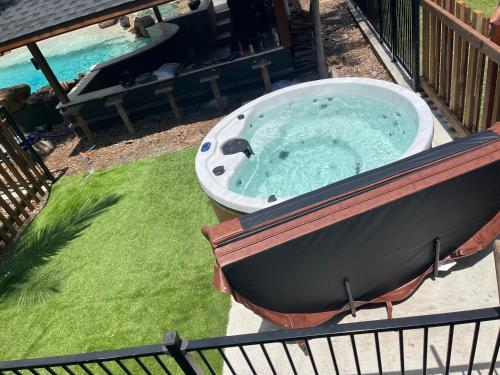 a jacuzzi tub on a deck in a yard at 2 Bedroom Cottage with Lagoon pool & spa in Capalaba