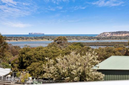 a view of the water and a ship in the distance at Luxurious Beach House with Breath-taking Views in Ocean Grove