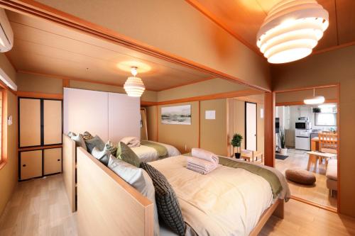 a bedroom with two beds in a room at プレジール弘前101 in Hirosaki