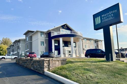 a building with a sign in front of it at MainStay Suites Madison Airport in Madison