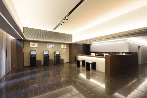 a lobby with a row of atm machines at Hakata Green Hotel Annex in Fukuoka