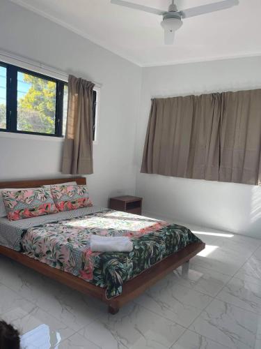 a bedroom with a bed and a window at Eryns Retreat in Avarua