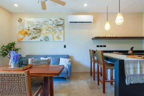 a kitchen and living room with a table and chairs at Calea Tulum Boutique Hotel in Tulum