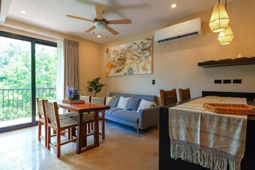 a living room with a table and a couch at Calea Tulum Boutique Hotel in Tulum