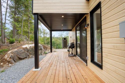 a wooden walkway leading to a house with windows at Ultra Luxurious Modern Chalet Private Jacuzzi in La Conception