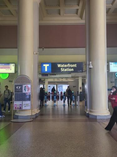 people walking through an airport with a sign that says treatment station at Downtown Center Silverstone Tower I and II Long-Term Booking Only Your second home in Vancouver in Vancouver