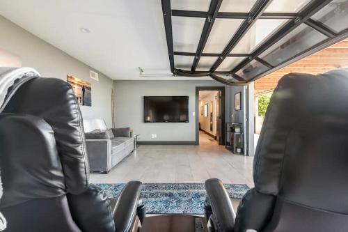 a living room with two chairs and a couch at Contemporary Ocean Sunset Views with Firepit Pt Loma close to PLNU in San Diego