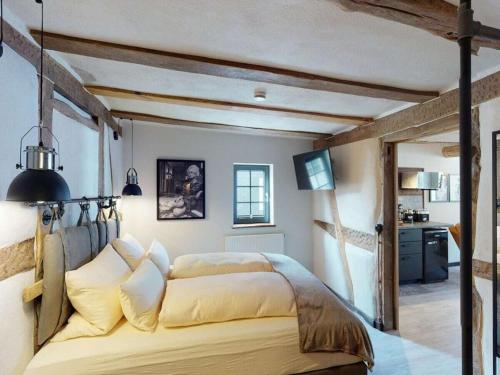 a bedroom with a large bed in a room at holiday apartment Vollmer´s Hof in Bad Berleburg