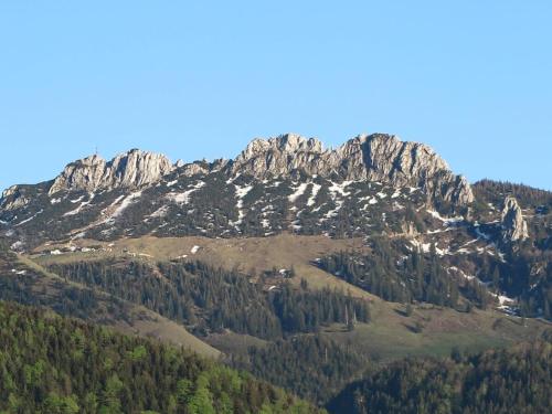 a large rocky mountain with trees in front of it at Schossbach in Haus Waldwinkel in Aschau im Chiemgau
