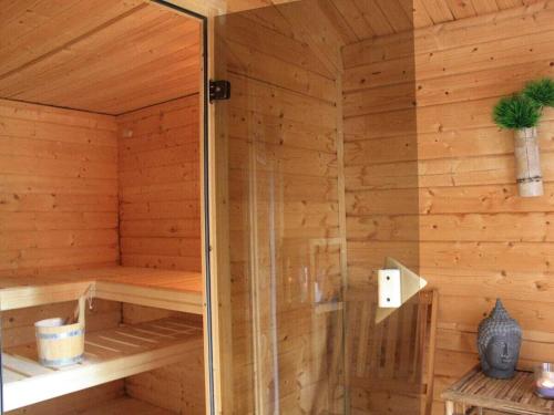 a wooden sauna with a shower in it at Coastal House Wremen in Wremerbüttel
