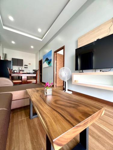 a living room with a couch and a table at N&D Poolvilla in Ao Nang Beach