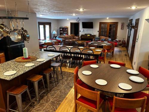 a restaurant with tables and chairs and a living room at The Chateau in Bloomington