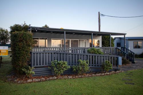 a house with a porch with a fence at South Coast Retreat in Greenwell Point