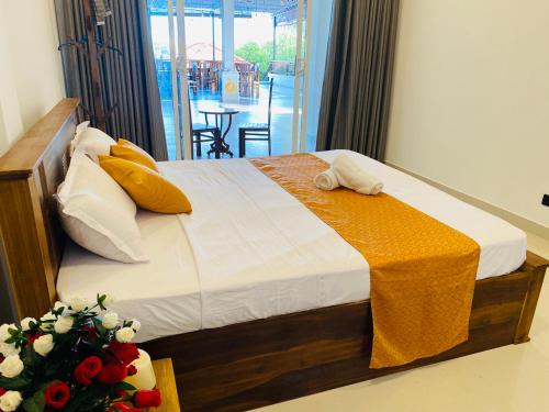 a bedroom with a bed with a towel on it at Aqua Hotel in Aluthgama