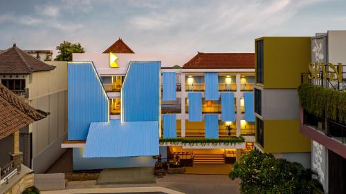 a view of a building with blue doors at Kampi Hotel Legian in Legian
