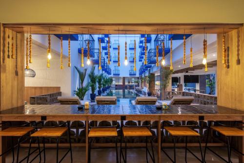a large dining room with a large table and chairs at Kampi Hotel Legian in Legian