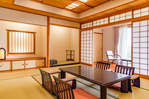 a dining room with a table and chairs at Onahama Ocean Hotel & Golf Club in Iwaki