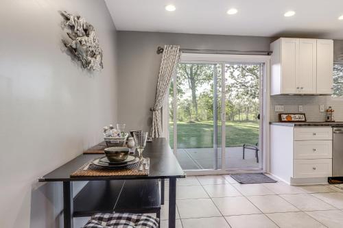 a kitchen with a table and a door to a yard at half Mi to Creation Museum Home with Large Yard! in Petersburg