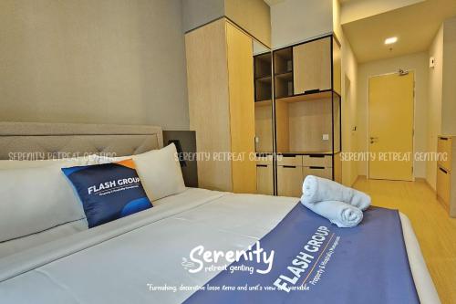 a bedroom with a large white bed with blue pillows at Windmill Upon Hills Serenity Retreat Genting in Genting Highlands