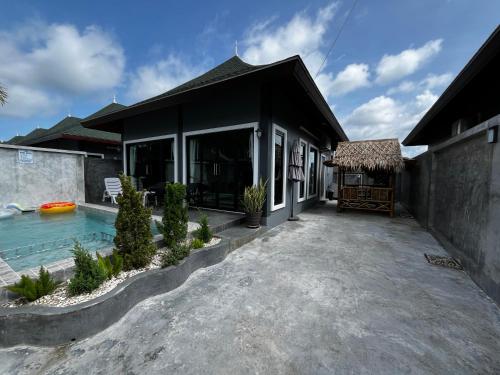 a home with a swimming pool and a house at N&D Poolvilla in Ao Nang Beach