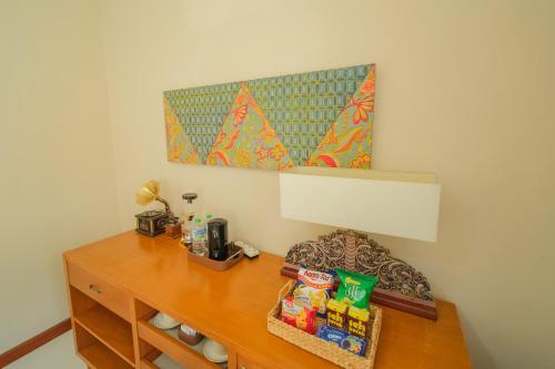 a room with a desk with snacks on it at Royal Brongto Hotel in Timuran