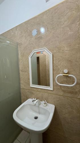 a bathroom with a sink and a mirror at La casa de los abuelos in Santiago del Estero