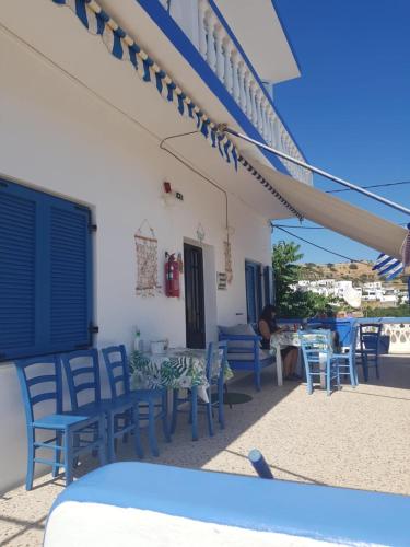 a group of chairs and tables on a patio at Hotel Glaros Lipsi in Lipsoi
