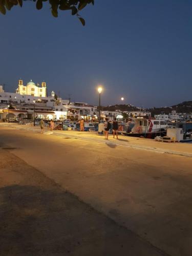 a group of people walking on a beach at night at Hotel Glaros Lipsi in Lipsoi