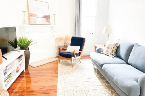 a living room with a couch and a chair at Red Brick Central Retreat in Wagga Wagga