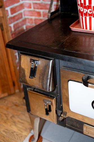 a stove with a counter top on top of it at Multi-Level Forest Lodge Near Silverwood with Vintage Ice Cream Parlor & Movie Theater in Spirit Lake