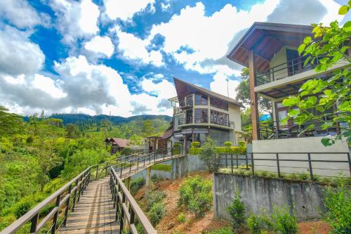 a house on a hill with stairs leading up to it at La Casa Lindula Villa Sarendip in Nuwara Eliya