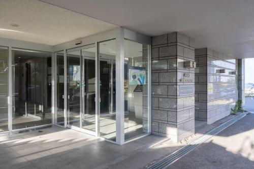 a building with glass doors on the side of it at Heart of Otaru, Condo, Port and Ocean view in Otaru