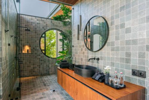 a bathroom with a sink and a mirror at Sea View Pool Villa - Exclusive Beachfront Property in Buleleng