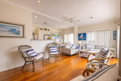 a living room with chairs and a couch at Mon Reve 4A Tallean Road three bedroom property with Wi-Fi, air conditioning in Nelson Bay