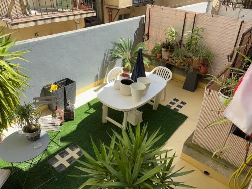 a table and chairs on a balcony with plants at Room near Nice Port in a shared apartment in Nice