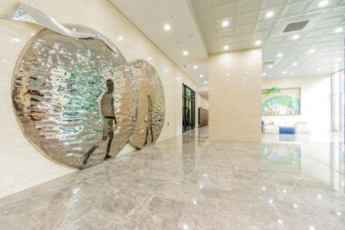 a lobby with an apple sculpture on the wall at Ariari Hotel in Jeongseon