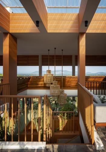 a room with a balcony with a view of the mountains at Amaya Kampot Homestays in Kampot