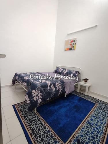 a couch in a living room with a blue rug at Homestay Kulim, Cempaka Homestay Desa Kayangan in Kampong Padang Meha