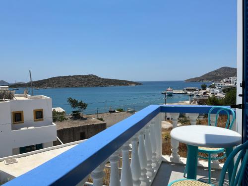 a balcony with a table and a view of the water at Hotel Glaros Lipsi in Lipsoi