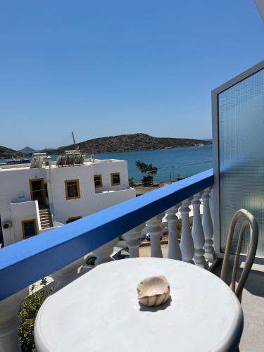 a shell sitting on a white table on a balcony at Hotel Glaros Lipsi in Lipsoi