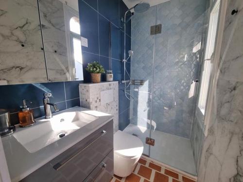 a bathroom with a sink and a shower and a toilet at Logement entier studio vue mer in Villers-sur-Mer