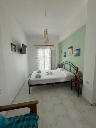 a bedroom with a bed and a window at Hotel Glaros Lipsi in Lipsoi