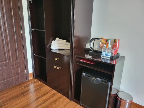 a closet with a black cabinet and a small appliance at RUBY HOTEL Vĩnh Long in Vĩnh Long