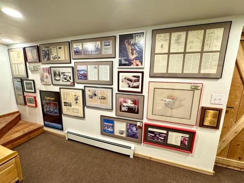 a wall of pictures on a wall in a room at Multi-Level Forest Lodge Near Silverwood with Vintage Ice Cream Parlor & Movie Theater in Spirit Lake