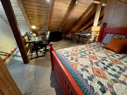 a bedroom with a large bed in a attic at Multi-Level Forest Lodge Near Silverwood with Vintage Ice Cream Parlor & Movie Theater in Spirit Lake