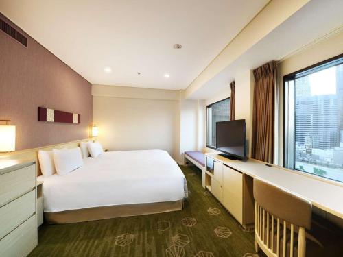a hotel room with a bed and a television at Shinjuku Prince Hotel in Tokyo