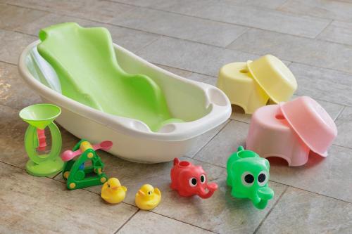 a group of toy toys sitting next to a bath tub at Tazawako Lake Resort & Onsen in Senboku
