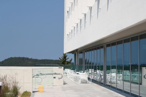 a view of the outside of a building with tables and chairs at Haenam 126 Hotel in Haenam